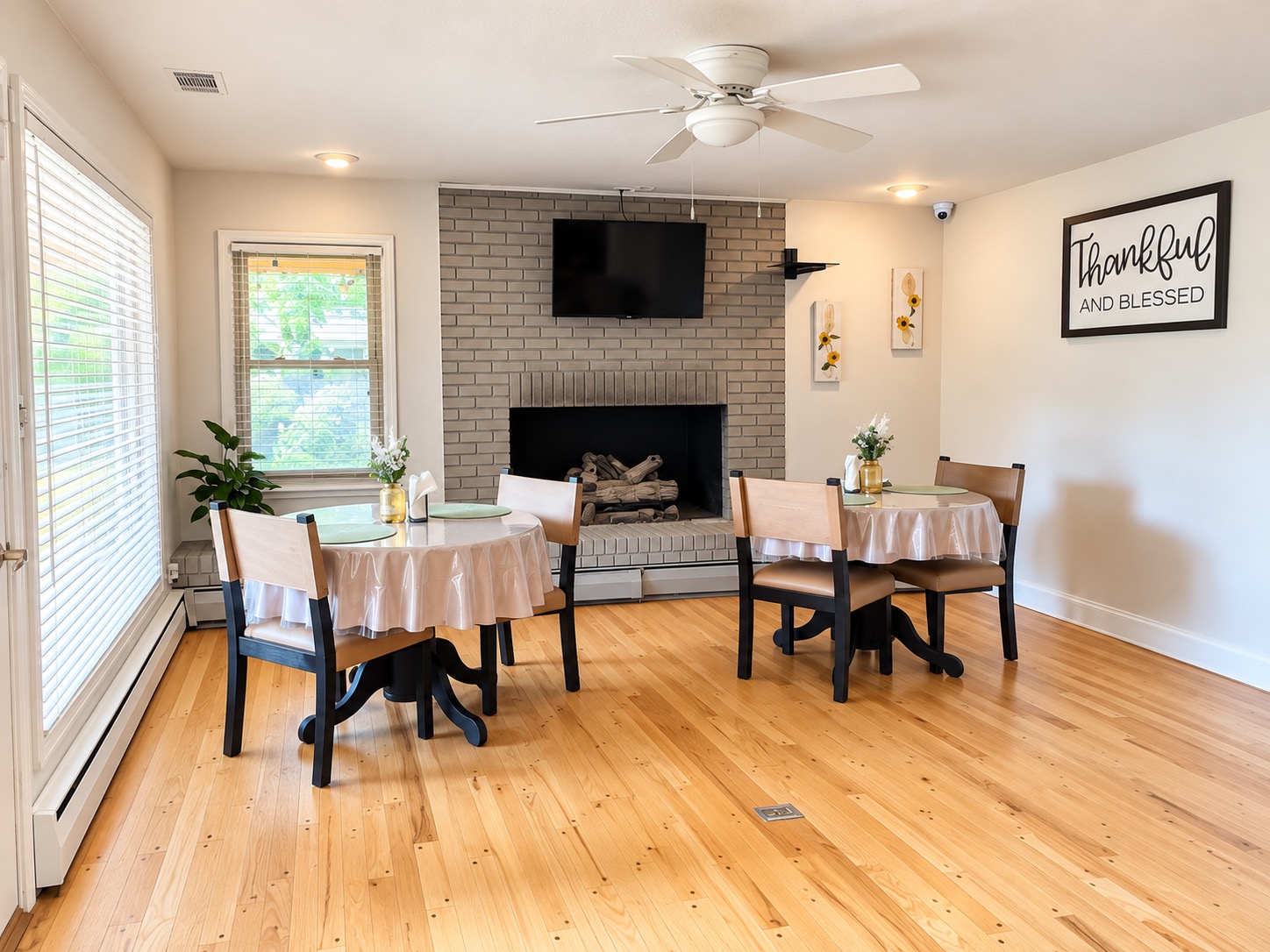 Dining area with two tables beside the fireplace