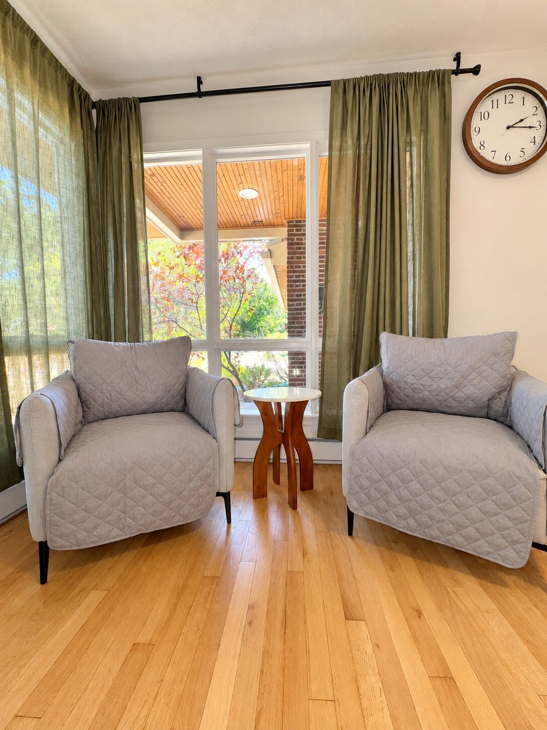 Two gray chairs in a sunny sitting area
