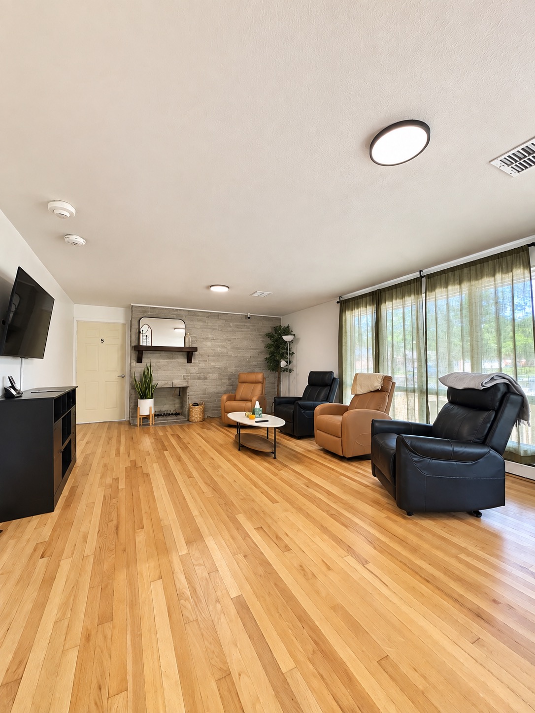 Living room with recliners and a view toward the windows